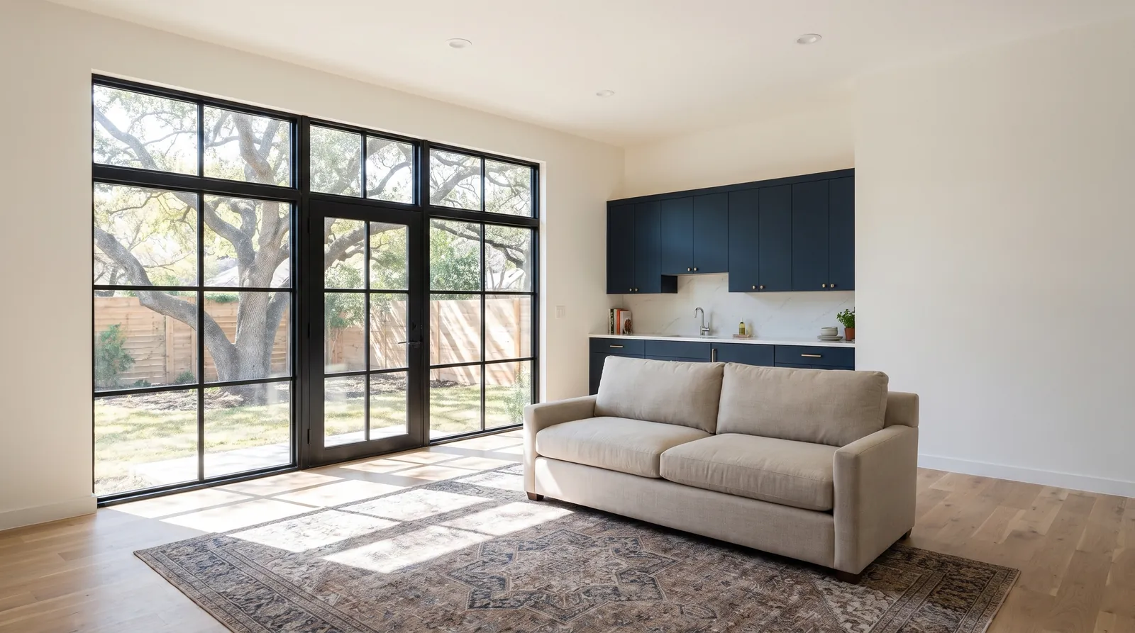 Two-car garage converted into a living space with a wall of black-framed windows