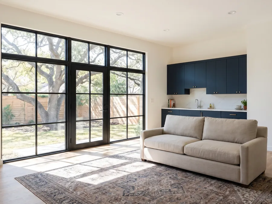 Two-car garage converted into a living space with a wall of black-framed windows