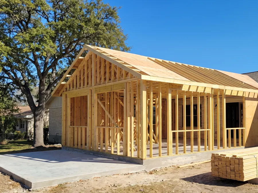 Room addition framed onto the back of a limestone ranch house
