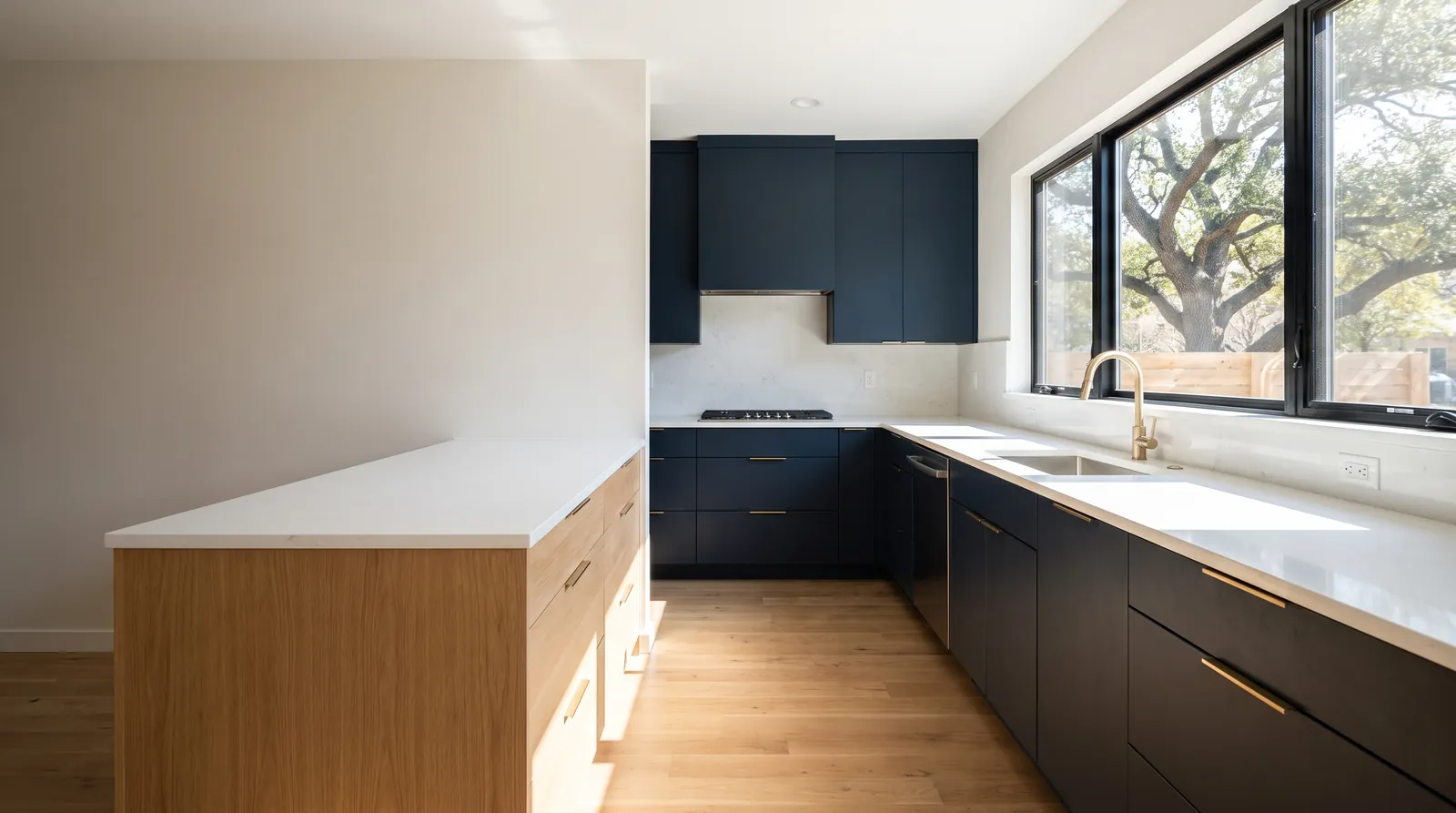 Remodeled kitchen with navy cabinets, a white oak island, and a window onto a live oak