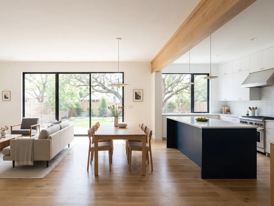 Opened-up living and dining room with a white oak beam where a wall came out